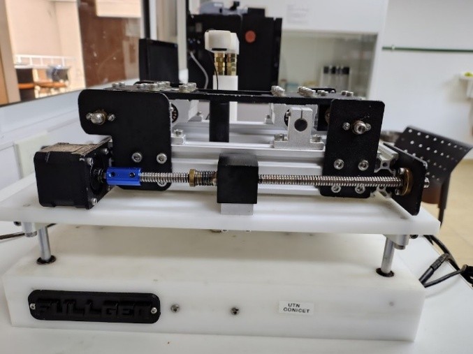 Side view. Detail of the mechanical assembly showing precision linear guides and stepper motor configuration.